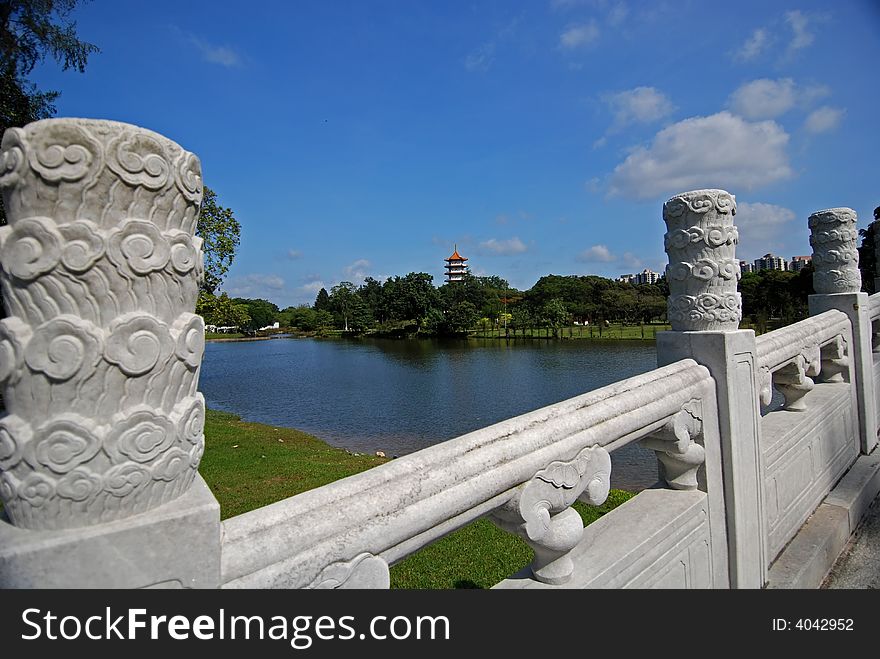 Stone Brige, Lake And Pagoda In The Park