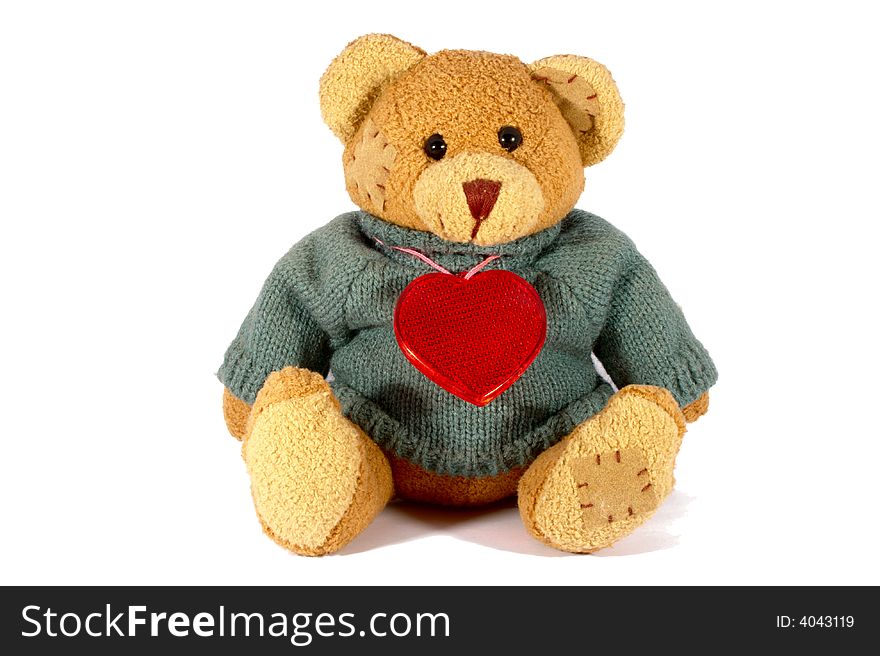 Isolated Taddy bear with plastic heart. White background.