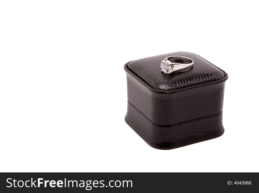 Large diamond encagement ring set in white gold, sitting on top of black box, isolated on white background. Large diamond encagement ring set in white gold, sitting on top of black box, isolated on white background.