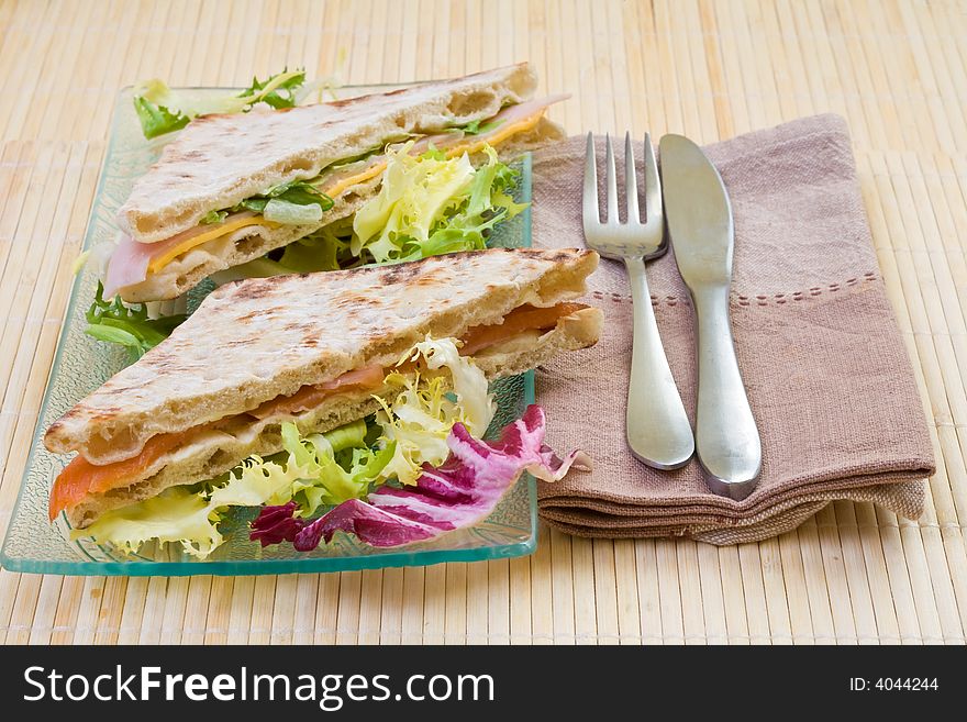 Healthy smoked salmon and vegetables big sandwich with salad. Healthy smoked salmon and vegetables big sandwich with salad