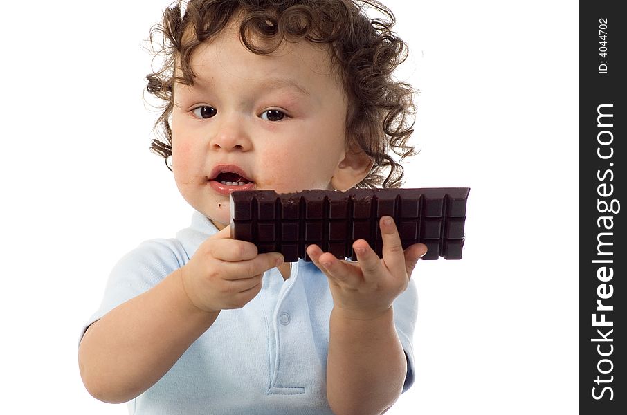 Child eats chocolate, isolated on a white background. Child eats chocolate, isolated on a white background.