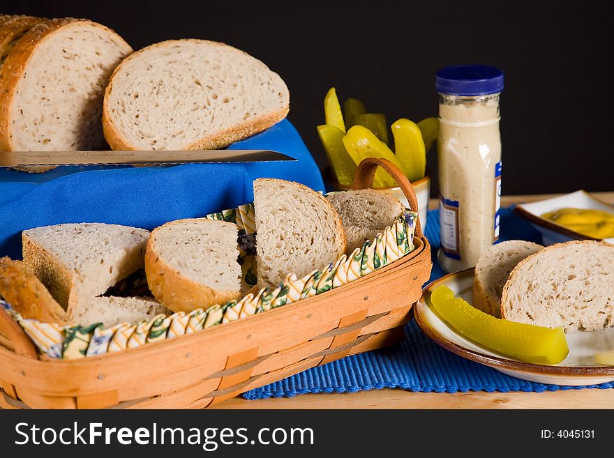 Still life of sliced rye bread with condiments.