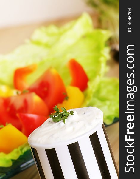 Resh salad with tomatoes and pepper behind cream cheese. Resh salad with tomatoes and pepper behind cream cheese