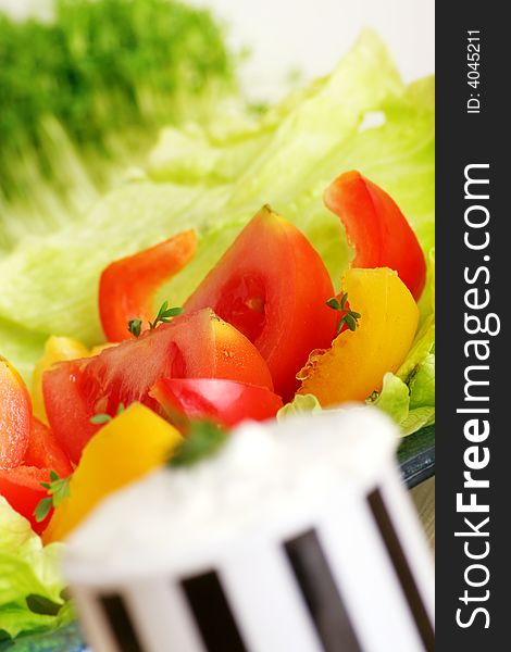 Resh salad with tomatoes and pepper behind cream cheese. Resh salad with tomatoes and pepper behind cream cheese