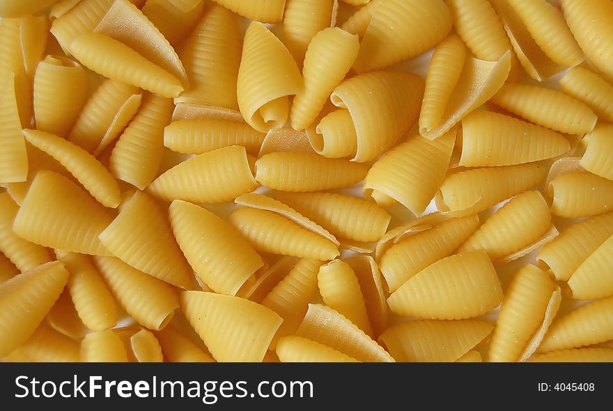 Raw uncooked italian pastaon white background.