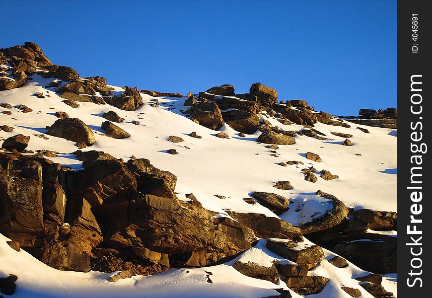 An undisturbed virgin mountain side with rocks staring up at the beautifully blue sky. An undisturbed virgin mountain side with rocks staring up at the beautifully blue sky