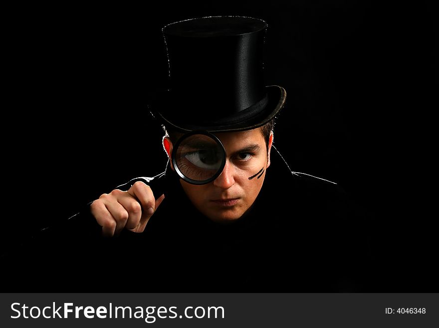 Young agent in cylinder hat with magnifying hat