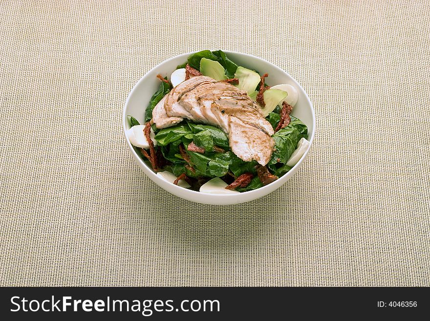 Salad with grilled chicken in the bowl