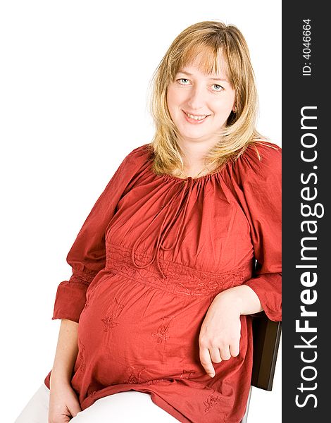 A pregnant lady smiling with a white background