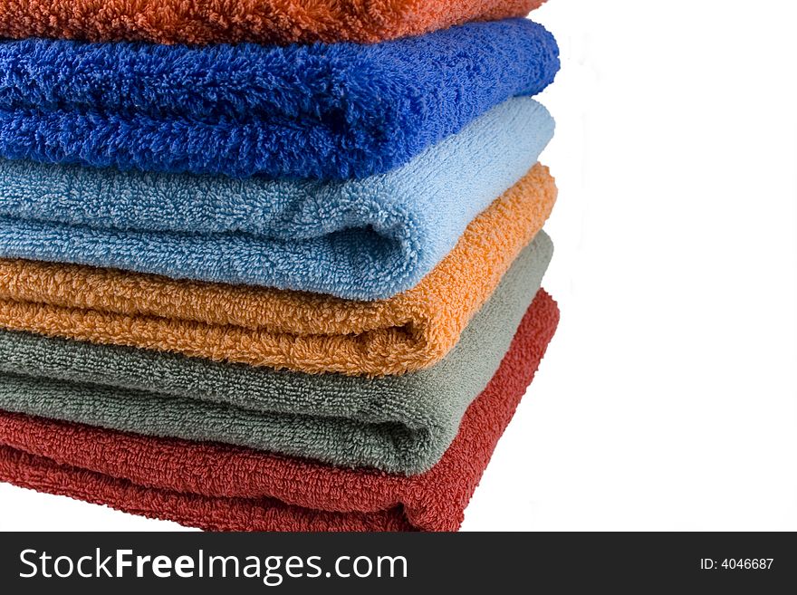 Stack of coloured towels isolataed over white