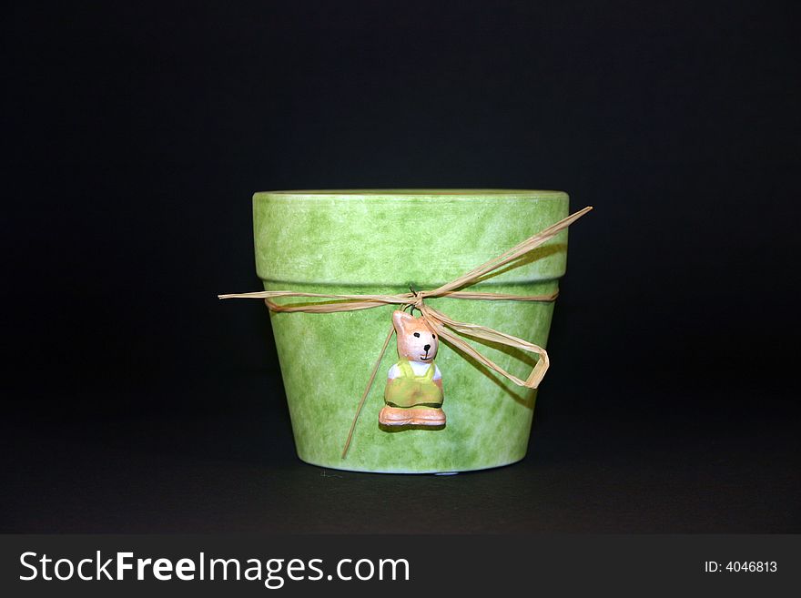 Green flower pot with a black background