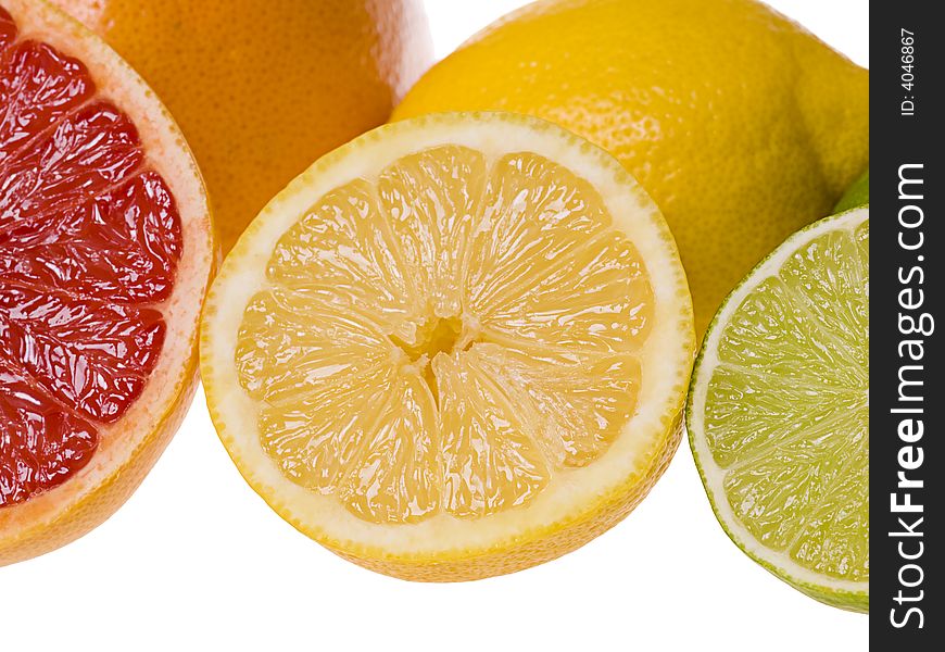 Set of slices of citrus fruits isolated on the white background. Focus on the lemon slice. Set of slices of citrus fruits isolated on the white background. Focus on the lemon slice.