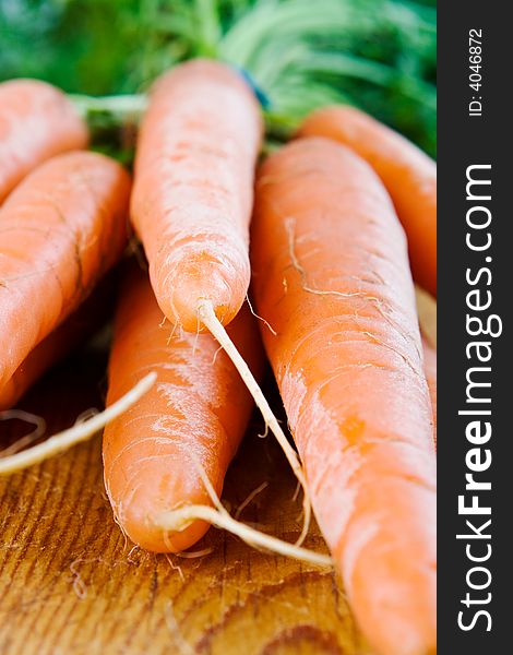 A bunch of carrots on a wooden board