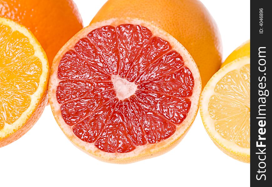 Set of slices of citrus fruits isolated on the white background. Focus on the grapefruit slice. Set of slices of citrus fruits isolated on the white background. Focus on the grapefruit slice.