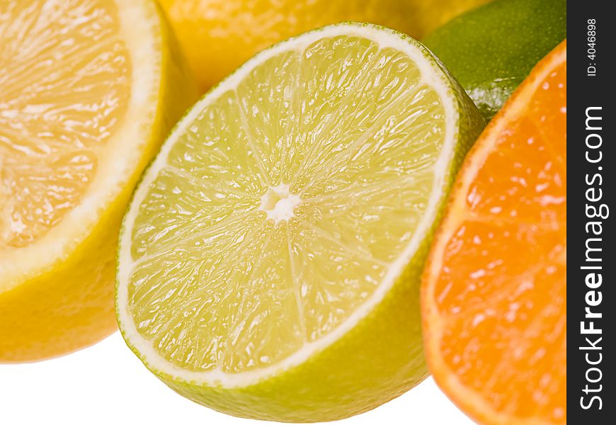 Set of slices of citrus fruits isolated on the white background. Focus on the lime slice. Set of slices of citrus fruits isolated on the white background. Focus on the lime slice.