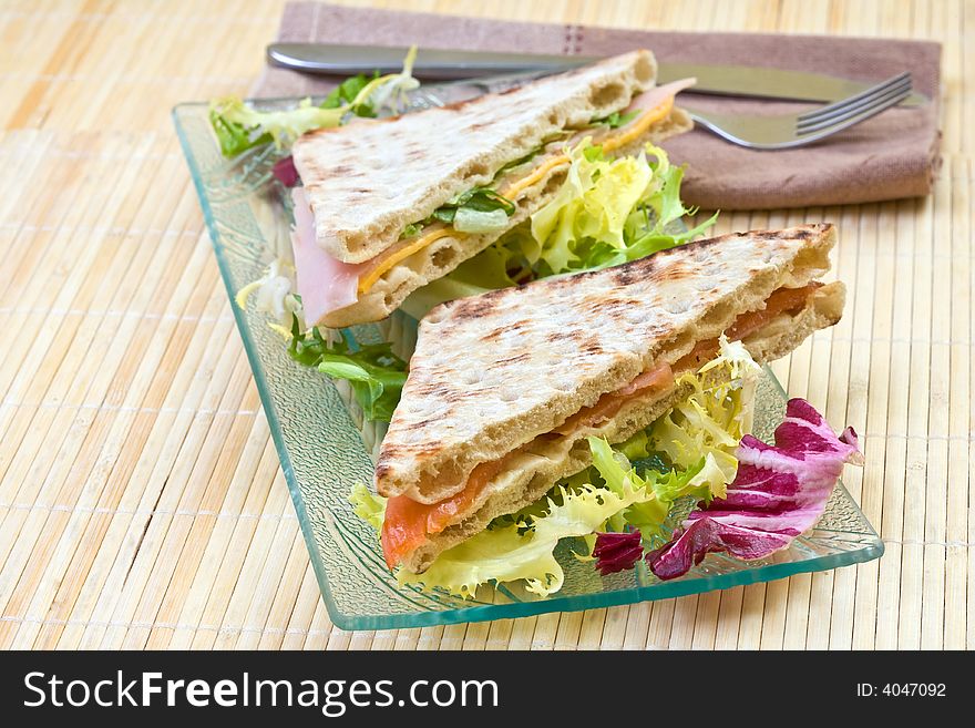 Healthy smoked salmon and vegetables big sandwich with salad. Healthy smoked salmon and vegetables big sandwich with salad