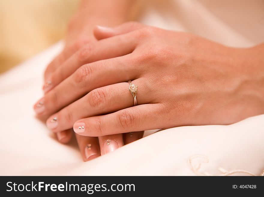 Close up of a brides hands showing a diamond ring and unique manicure. Close up of a brides hands showing a diamond ring and unique manicure