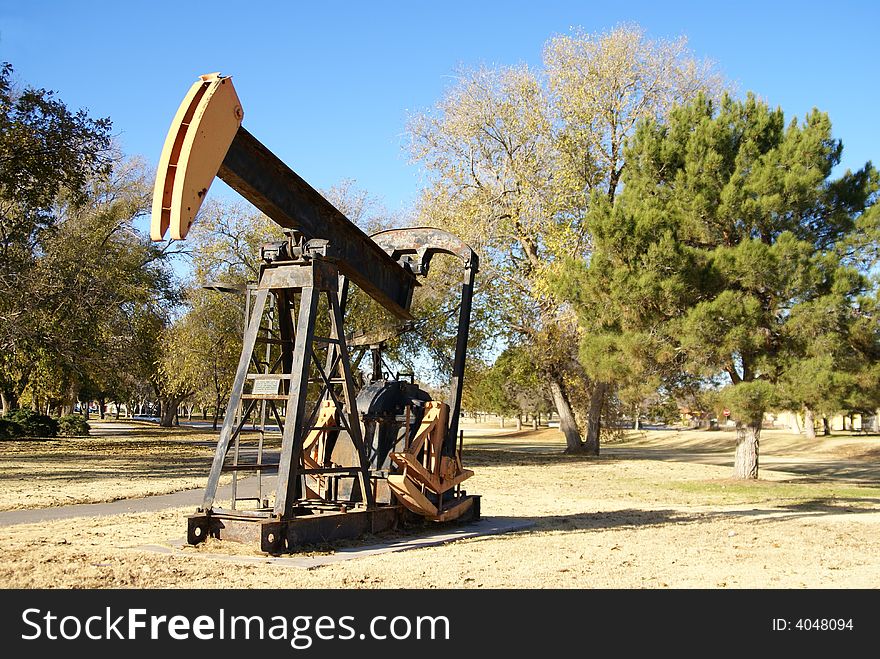 Retired oil pump jack in a park