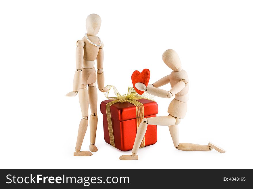 Little wooden Man offering his heart to a little wooden woman. Valentine's day card. Isolated on white background. Clipping path included. Little wooden Man offering his heart to a little wooden woman. Valentine's day card. Isolated on white background. Clipping path included.