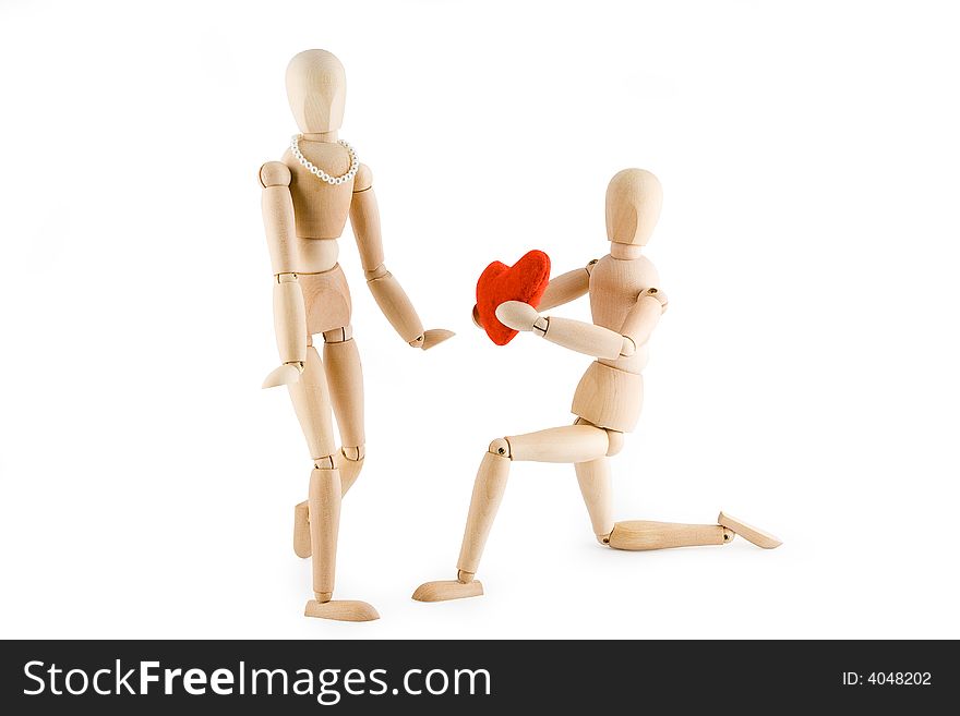 Little wooden Man offering his heart to a little wooden woman. Valentine's day card. Isolated on white background. Clipping path included. Little wooden Man offering his heart to a little wooden woman. Valentine's day card. Isolated on white background. Clipping path included.