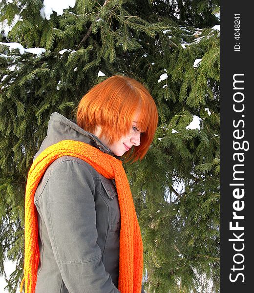 Red-haired girl with orange scarf and green fir