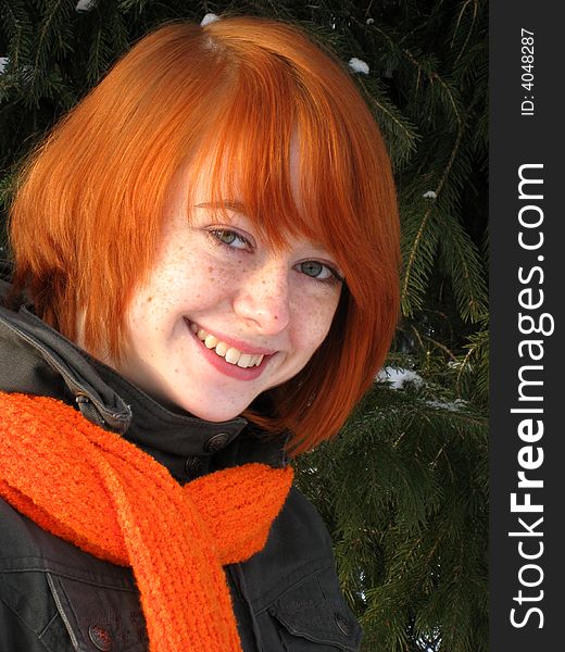 Red-haired girl with orange scarf and green fir