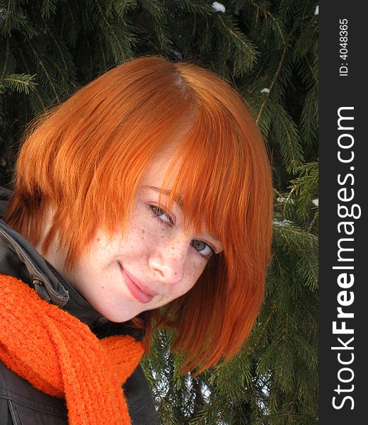Red-haired girl with orange scarf and green fir
