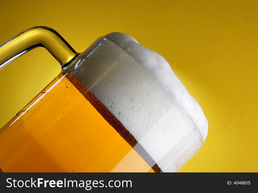 Beer mug with froth close-up