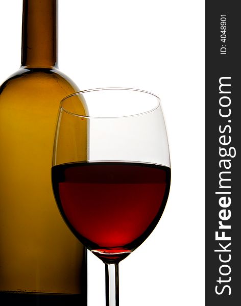 Bottle and glass of red wine isolated over white background