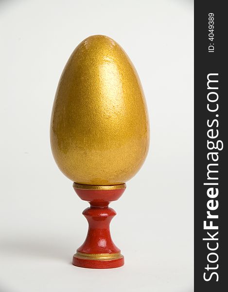 Gold easter egg on a red support. Gold easter egg on a red support.