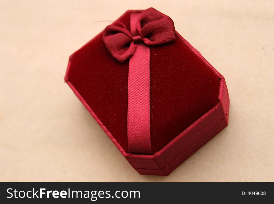 A red open gift box isolated on beige background. A red open gift box isolated on beige background