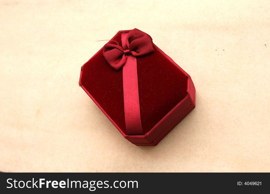 A red open gift box isolated on beige background. A red open gift box isolated on beige background