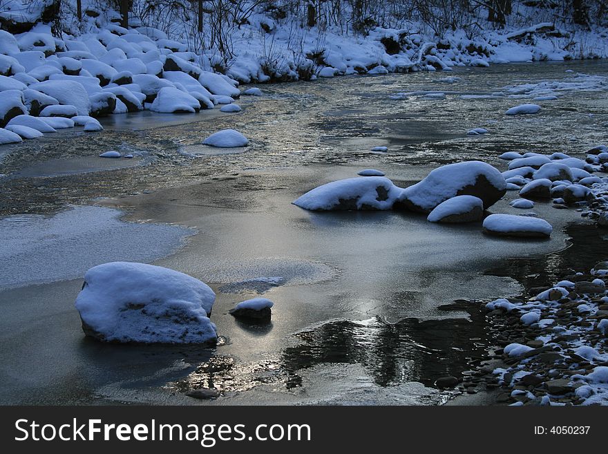 A river after the first winter snowfall near Cleveland Ohio. A river after the first winter snowfall near Cleveland Ohio.