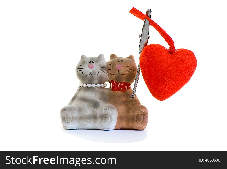 Figurine in the form of a cat and a cat with heart. Isolated on white. Figurine in the form of a cat and a cat with heart. Isolated on white