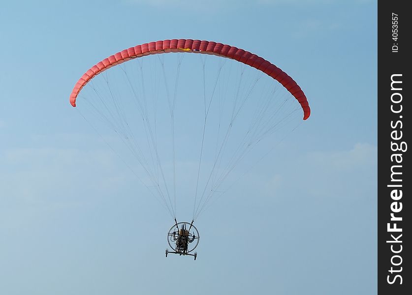 Paramotor with wheels, a motorized paraglider, flying. Paramotor with wheels, a motorized paraglider, flying.