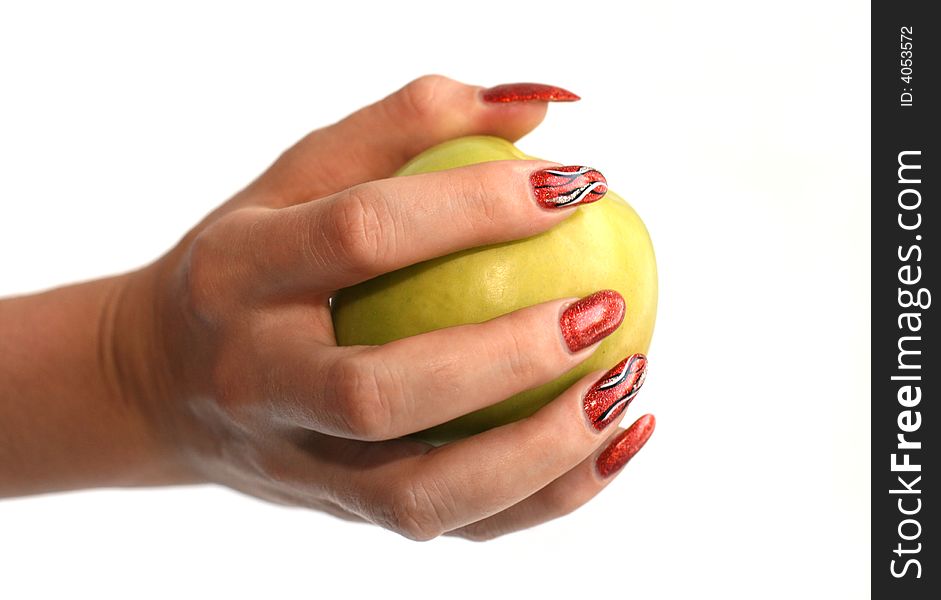 Female fingers with manicure hold an apple