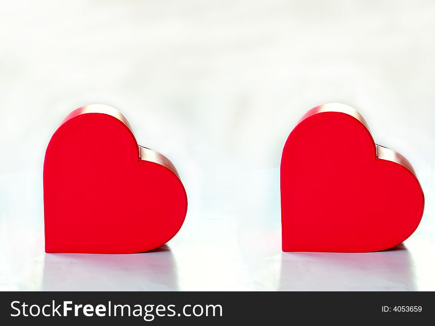 Two hearts over white background