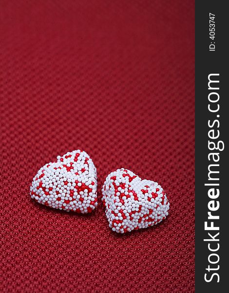 A Couple of Valentine heart candy over red background. A Couple of Valentine heart candy over red background