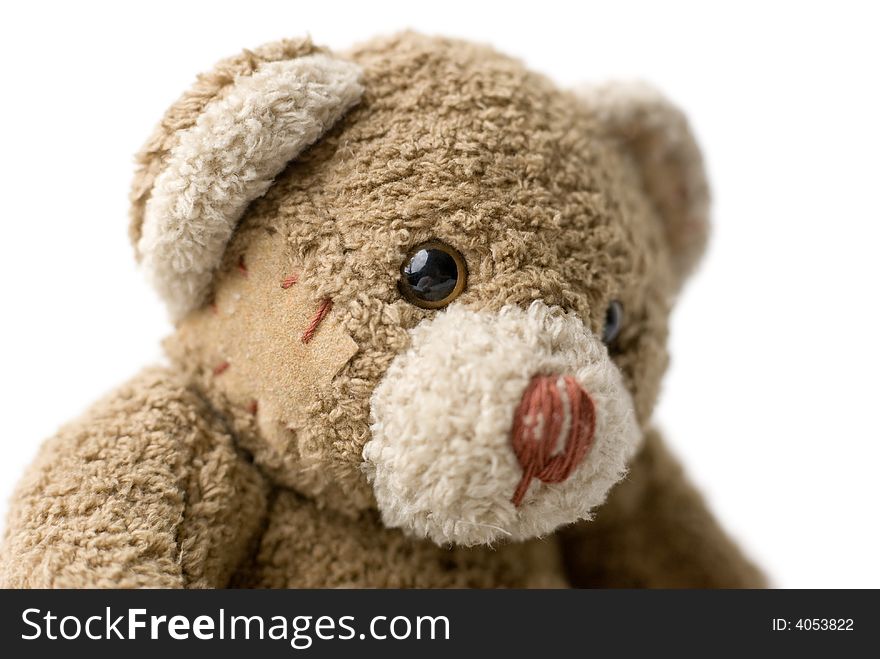 Patched teddy bear portrait - selective focus on the eye. Patched teddy bear portrait - selective focus on the eye.