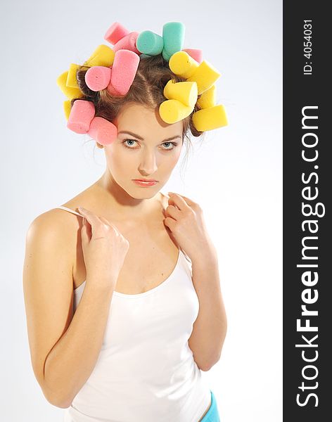 A woman in hair curlers