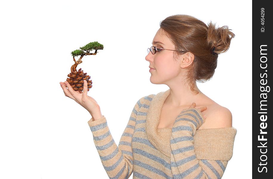 Beautiful young girl with plant isolated over a white background