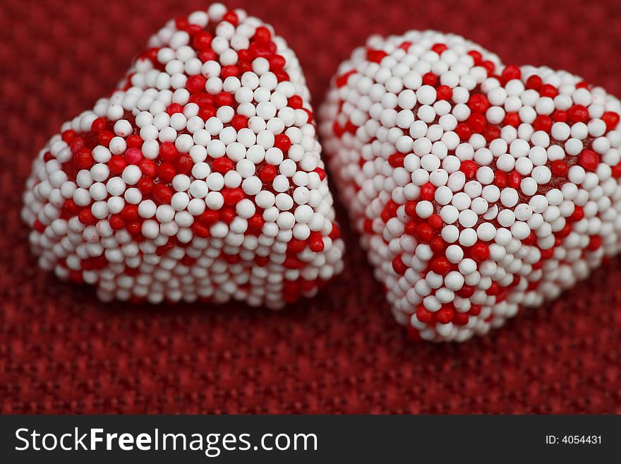 A Couple of Valentine heart candy over red background. A Couple of Valentine heart candy over red background