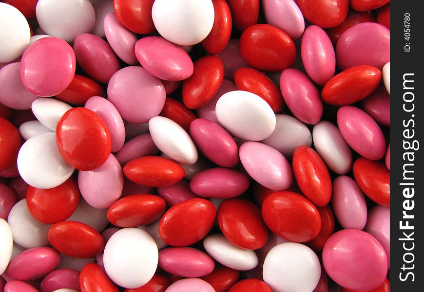 Macro of chocolate candies bright red and pinks. Macro of chocolate candies bright red and pinks