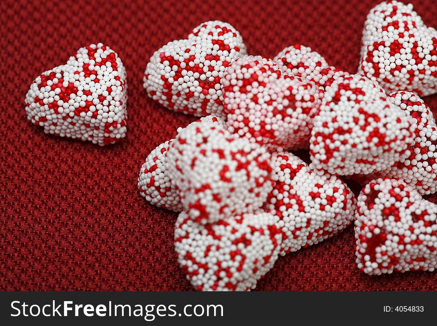 A group of Valentine heart candy over red background. A group of Valentine heart candy over red background