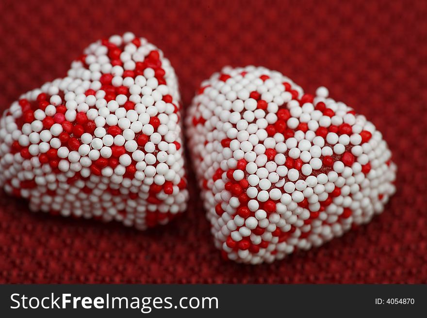 A group of Valentine heart candy over red background. A group of Valentine heart candy over red background