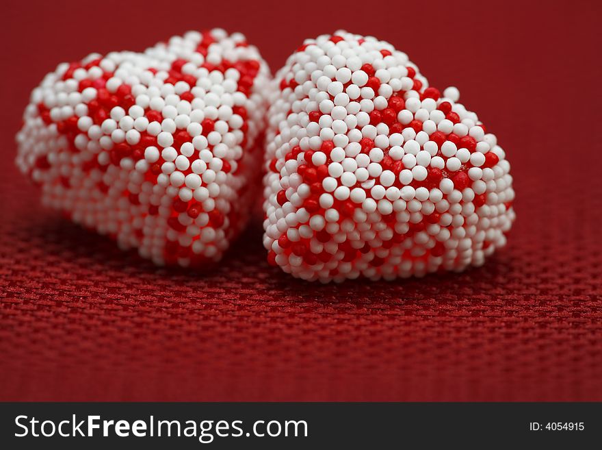 A group of Valentine heart candy over red background. A group of Valentine heart candy over red background