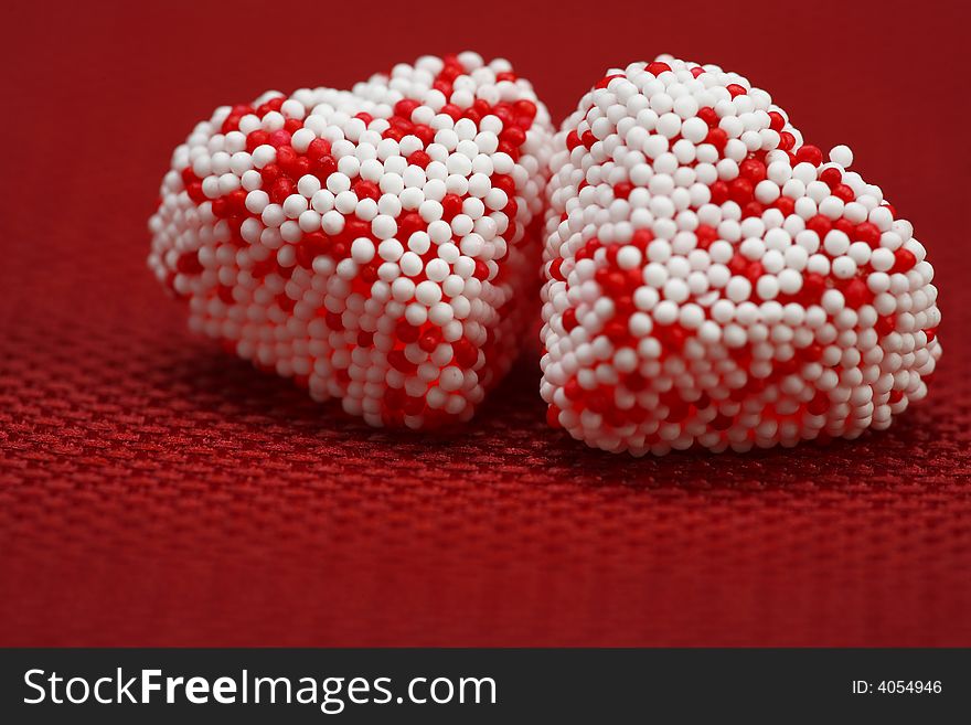 A group of Valentine heart candy over red background. A group of Valentine heart candy over red background