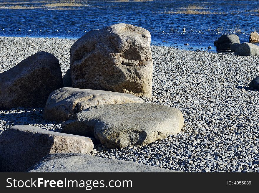 Stone on the winter lake shore