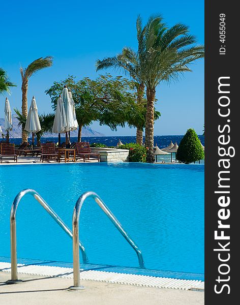 Beautiful swimming pool and ocean in background