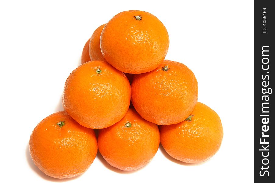 Pyramid from tasty ripe tangerines on a white background. Pyramid from tasty ripe tangerines on a white background.